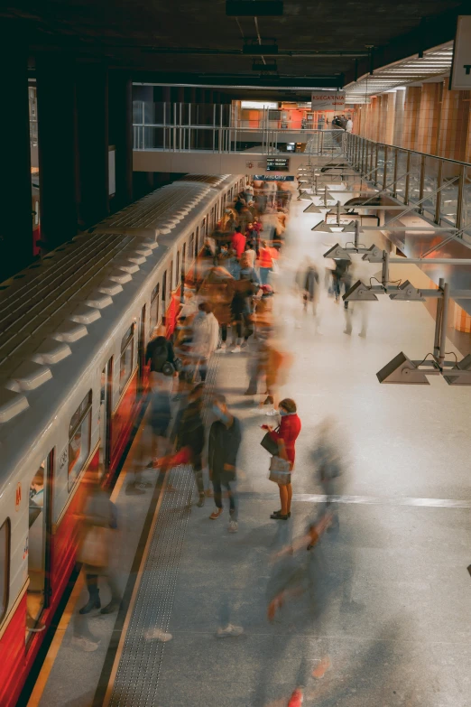 a large group of people are walking and leaving the subway