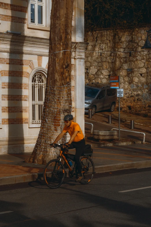 there is a person riding a bike down the street