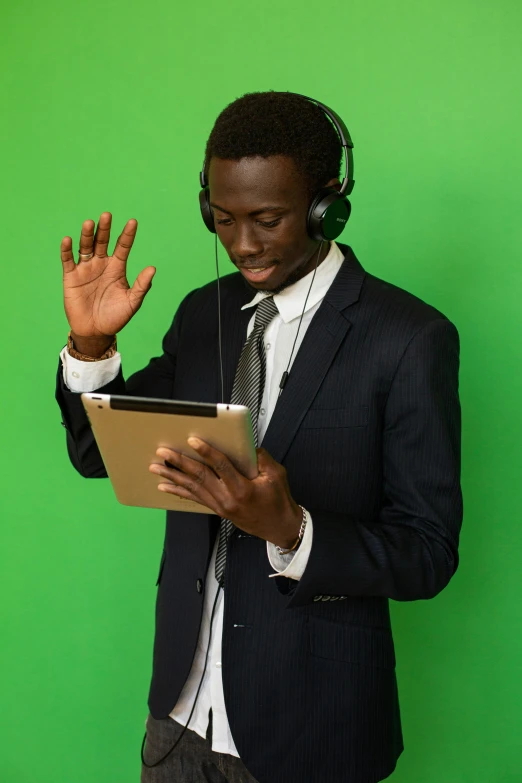 man with headphones holding a digital tablet