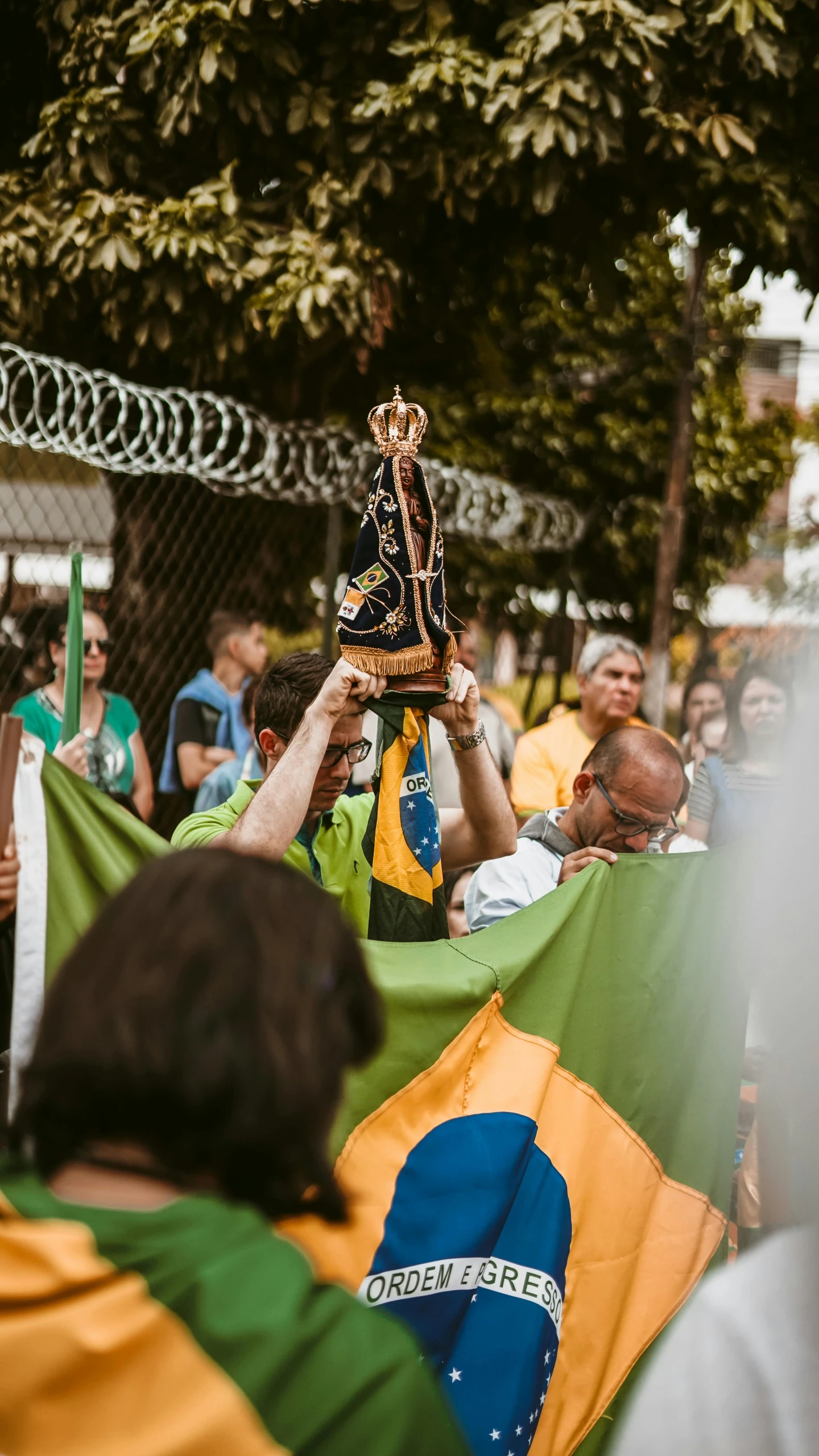 a man holding up a trophy and a sign