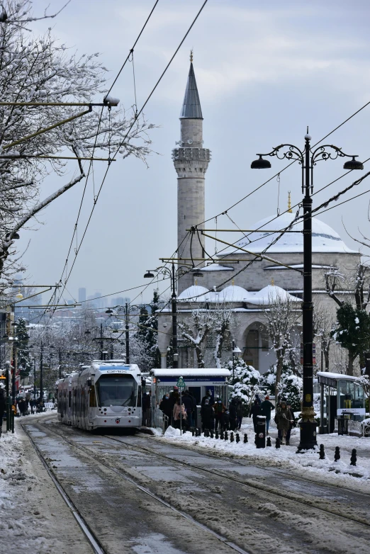 an open air bus stop next to a snowy street