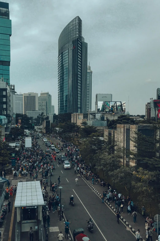 an outdoor street with people riding motorcycles and some buildings