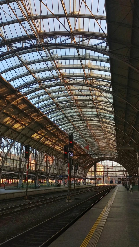 inside a large subway station with a clock on the front