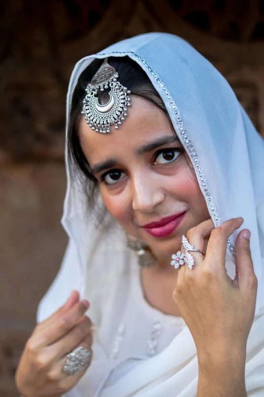 a woman in white is posing for the camera