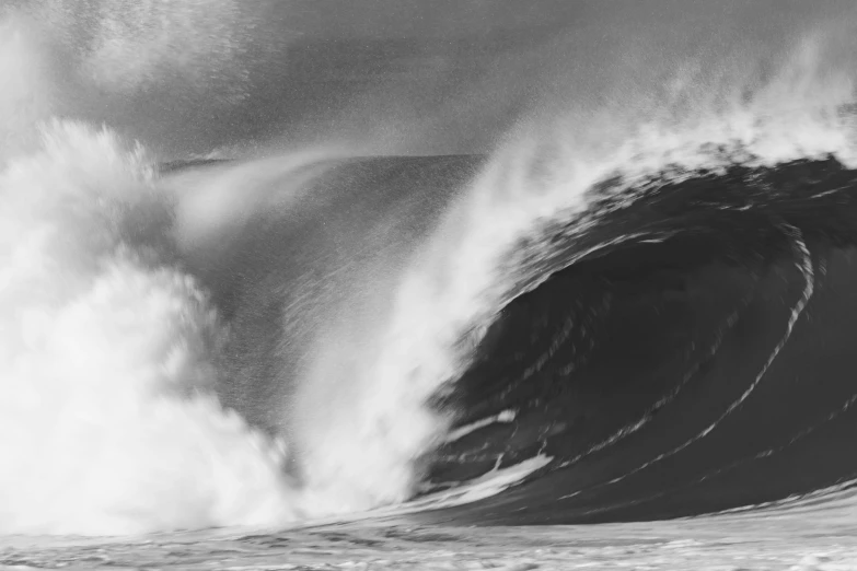 large ocean wave with spray coming from it's back