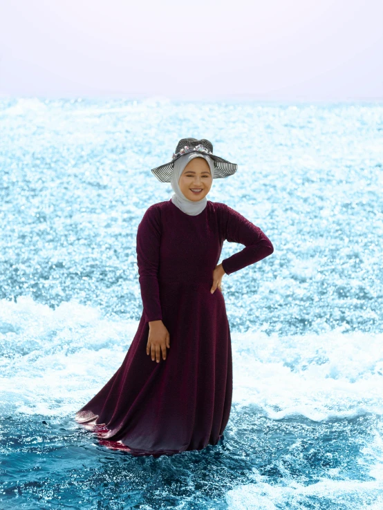 a woman standing in water near the shore