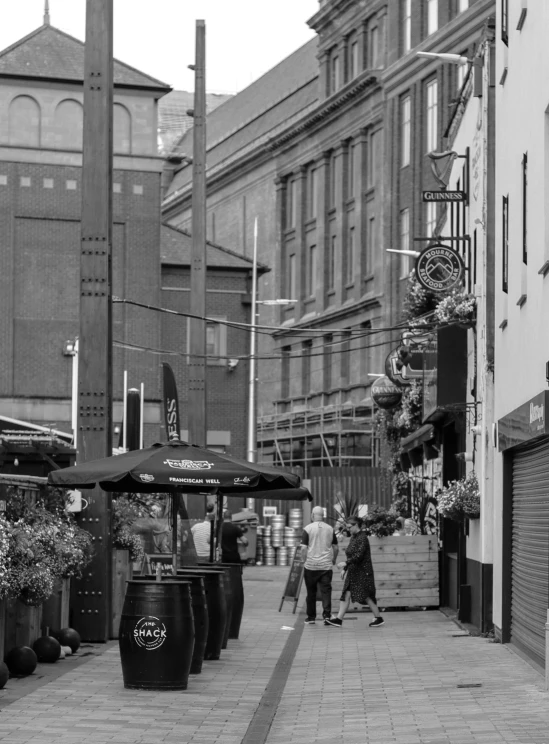 a person walks on a sidewalk near a row of buildings