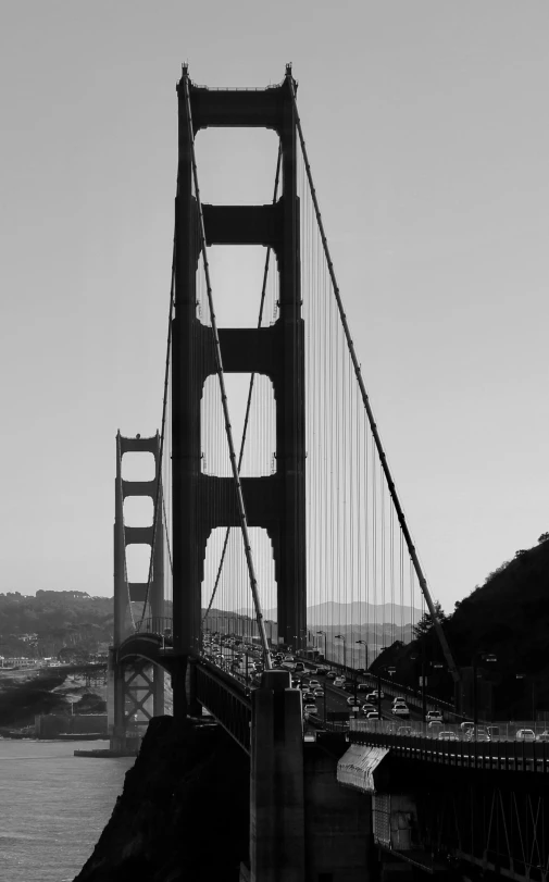 a bridge over a body of water with buildings behind it