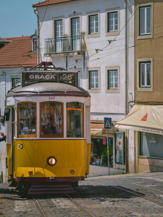 a train on a track with buildings in the background