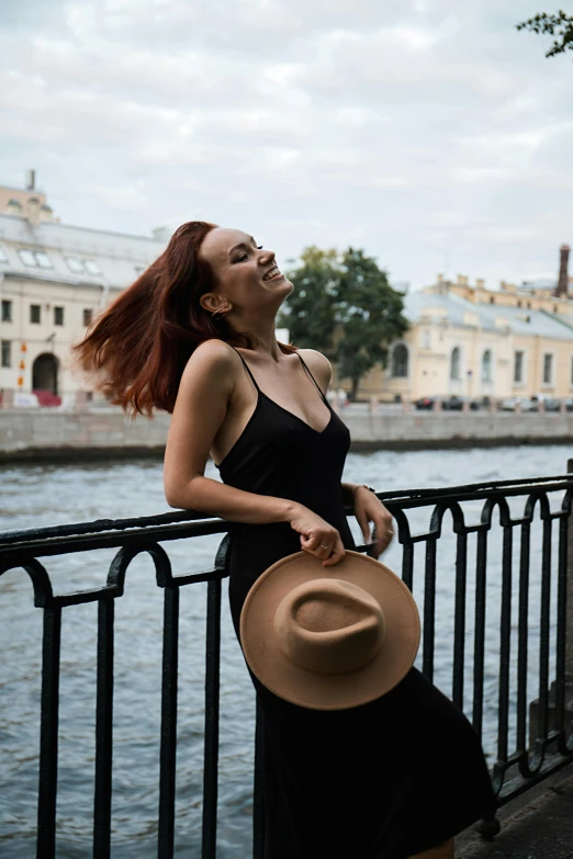 a woman stands on a rail looking up at the sky