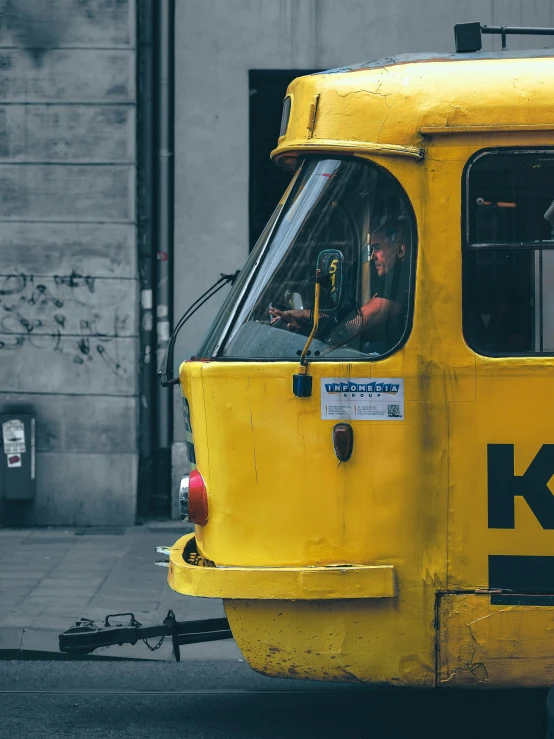 the man is driving the yellow cab over the road