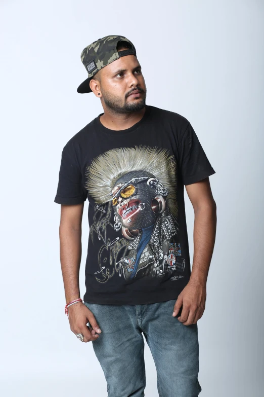 a man wearing a hat and a t - shirt is posing for a po