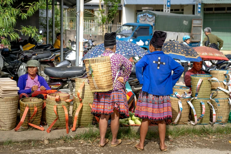 a couple of people standing by some baskets