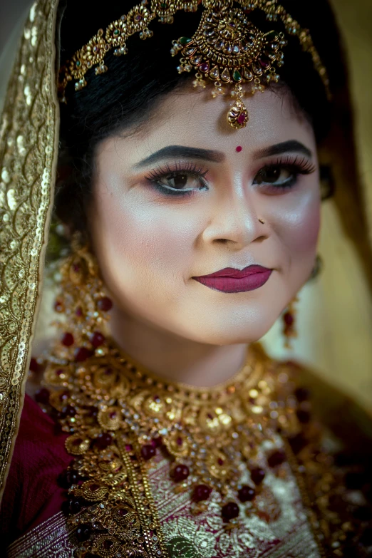 a close up image of a woman wearing a traditional indian outfit
