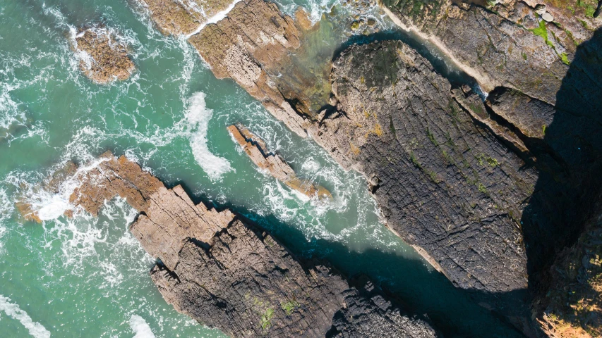 aerial pograph of rocky terrain by ocean