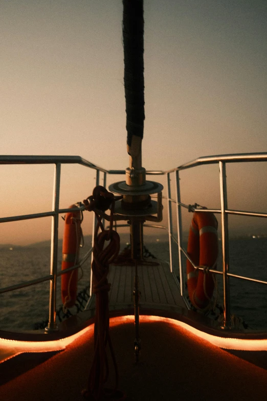 an orange life preserver sits on the edge of a boat