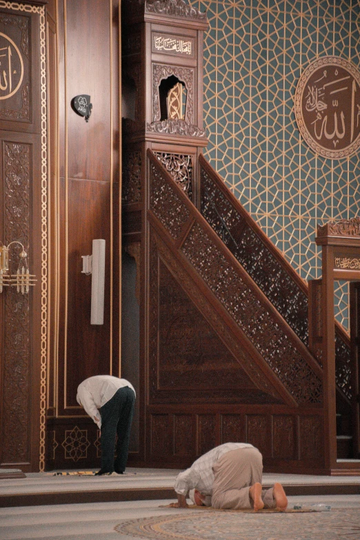 a person kneeling down on the floor next to a staircase