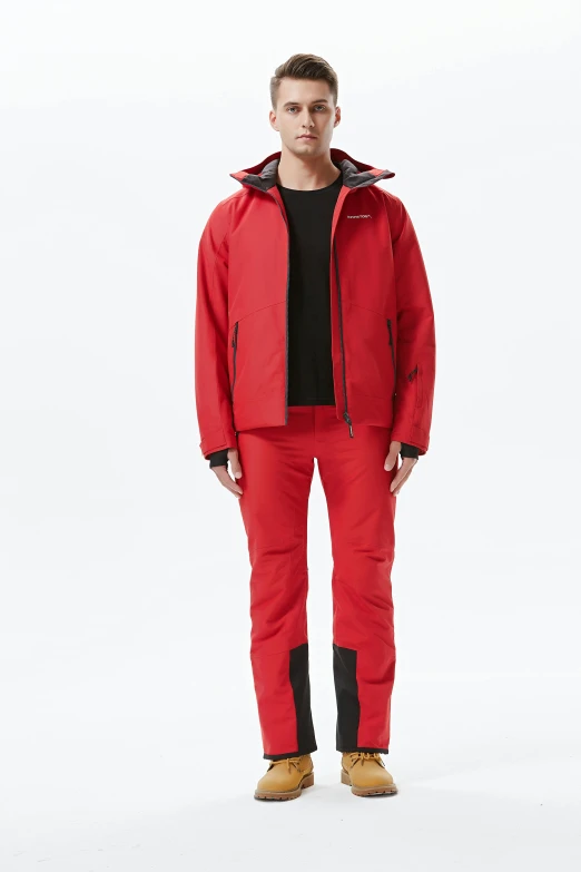 man in red ski suit standing against a white background