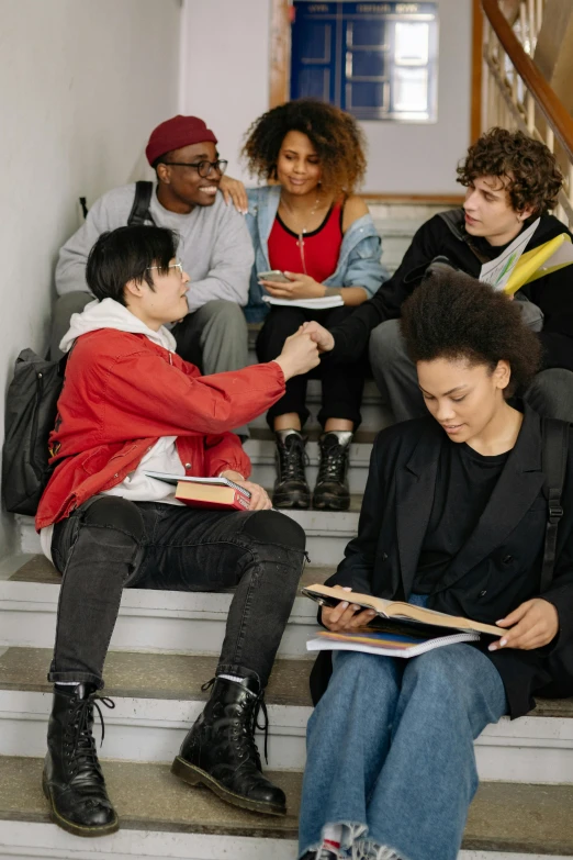 a group of s on steps playing and reading