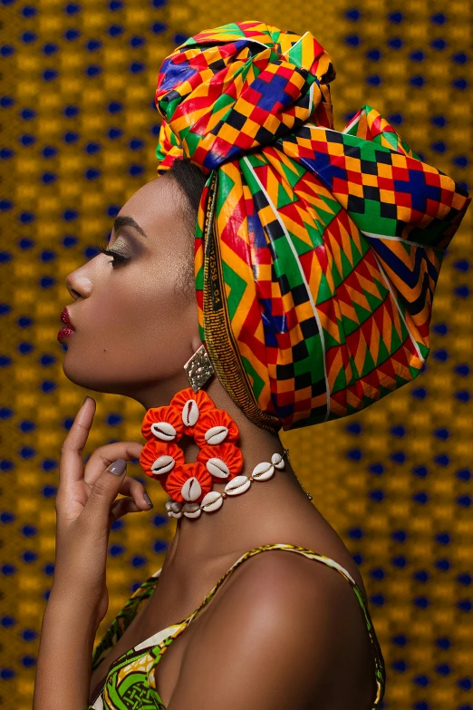 a woman in an african headwrap posing for a picture