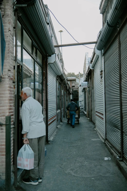 older people are walking down the sidewalk in the old town