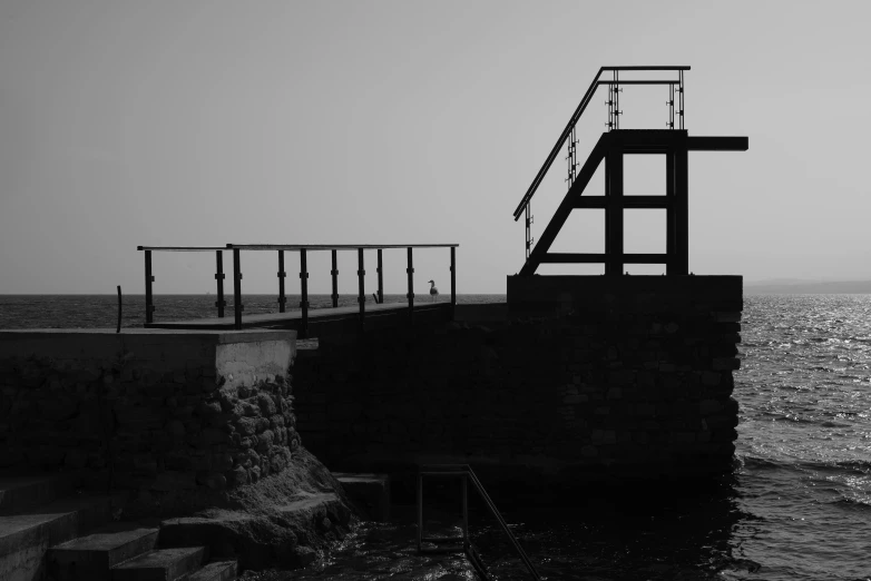 a lighthouse is at the edge of a body of water