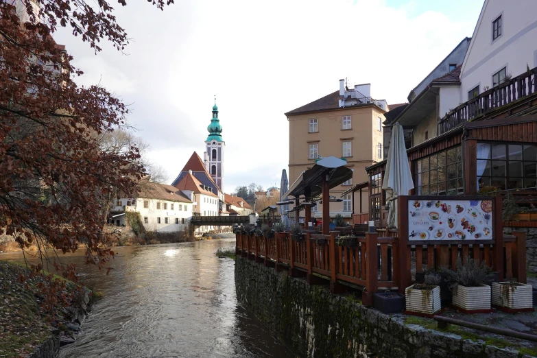 a small bridge over a narrow canal in a town