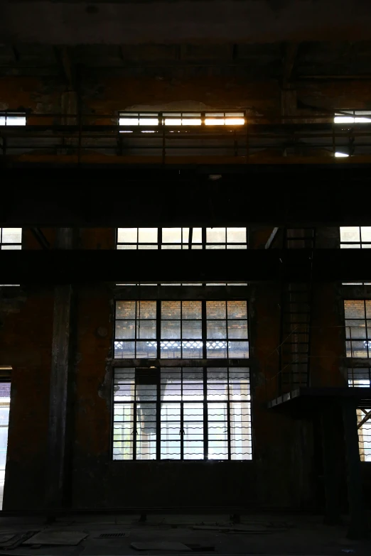 an empty room with three windows next to the floor