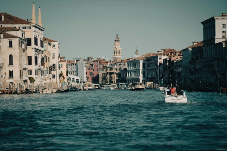 a boat in the water near some buildings