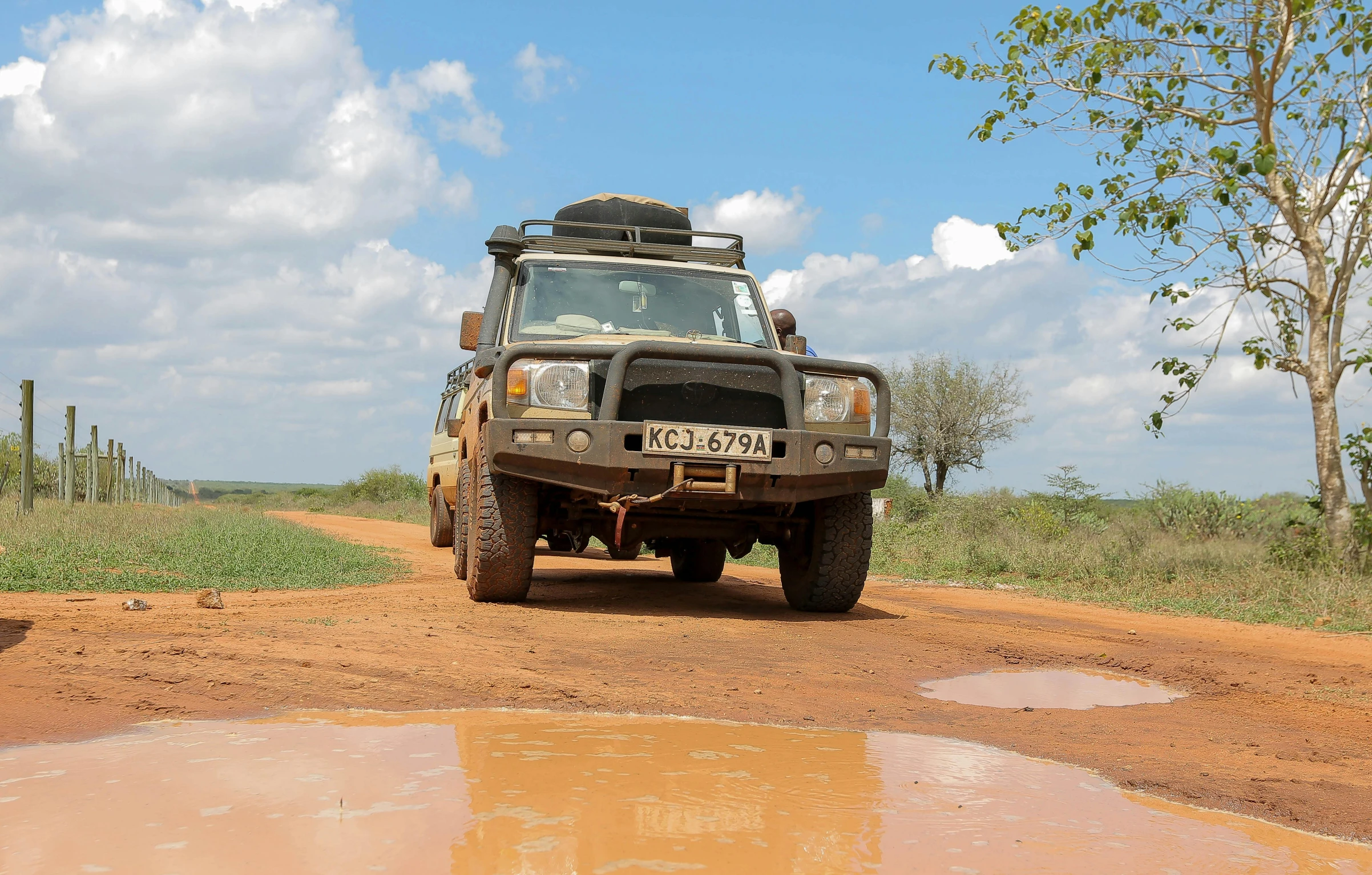 the vehicle on the dirt road is parked