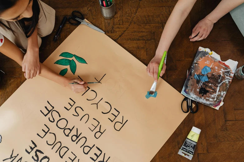 some people are holding a hand made sign