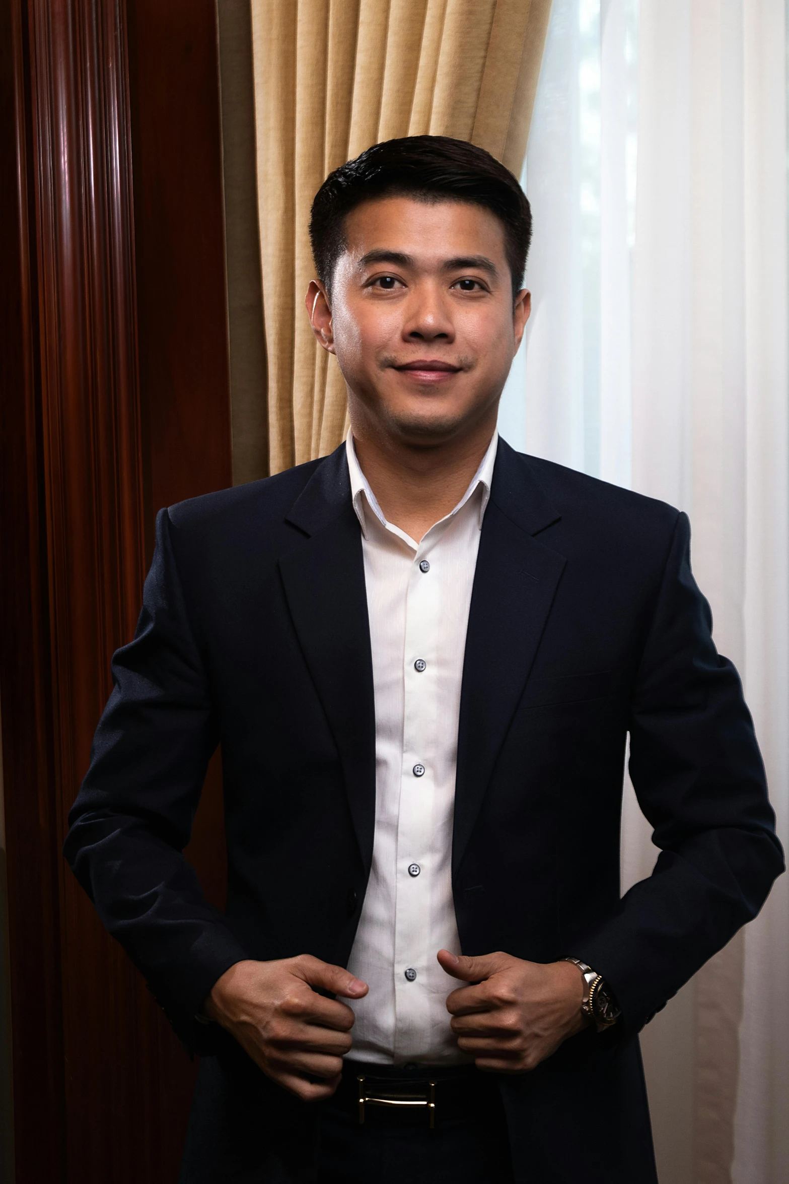 a man in a black suit and white shirt