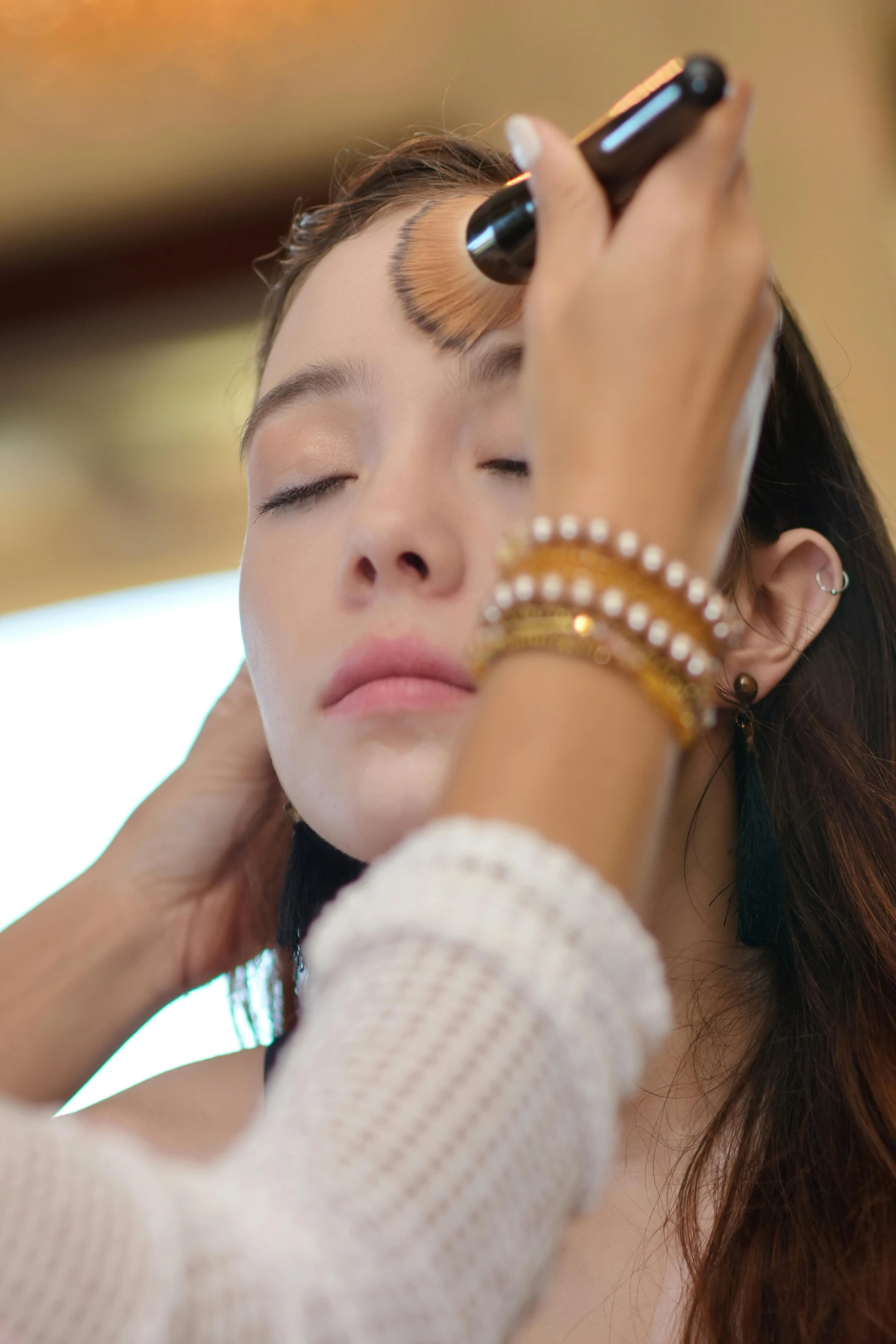 a woman is having her makeup done in the middle of a po