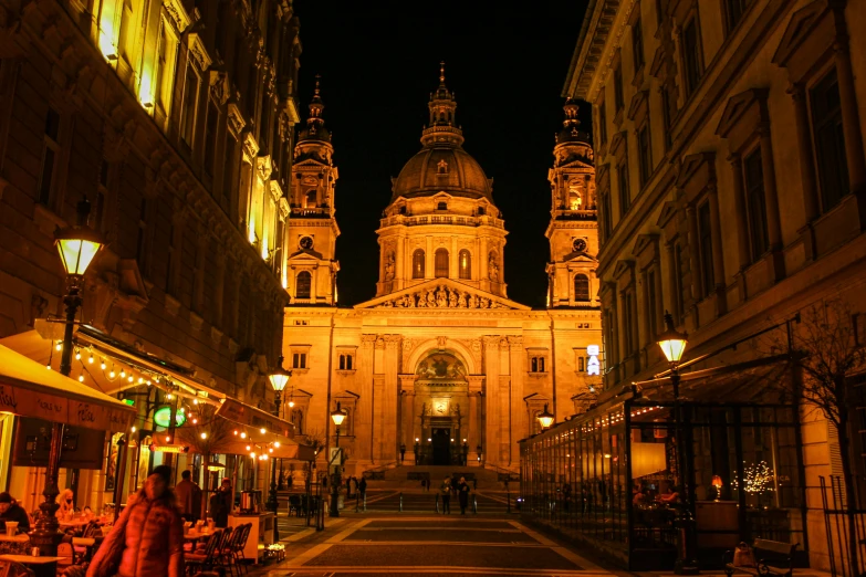 a very narrow and big building with lamps on it