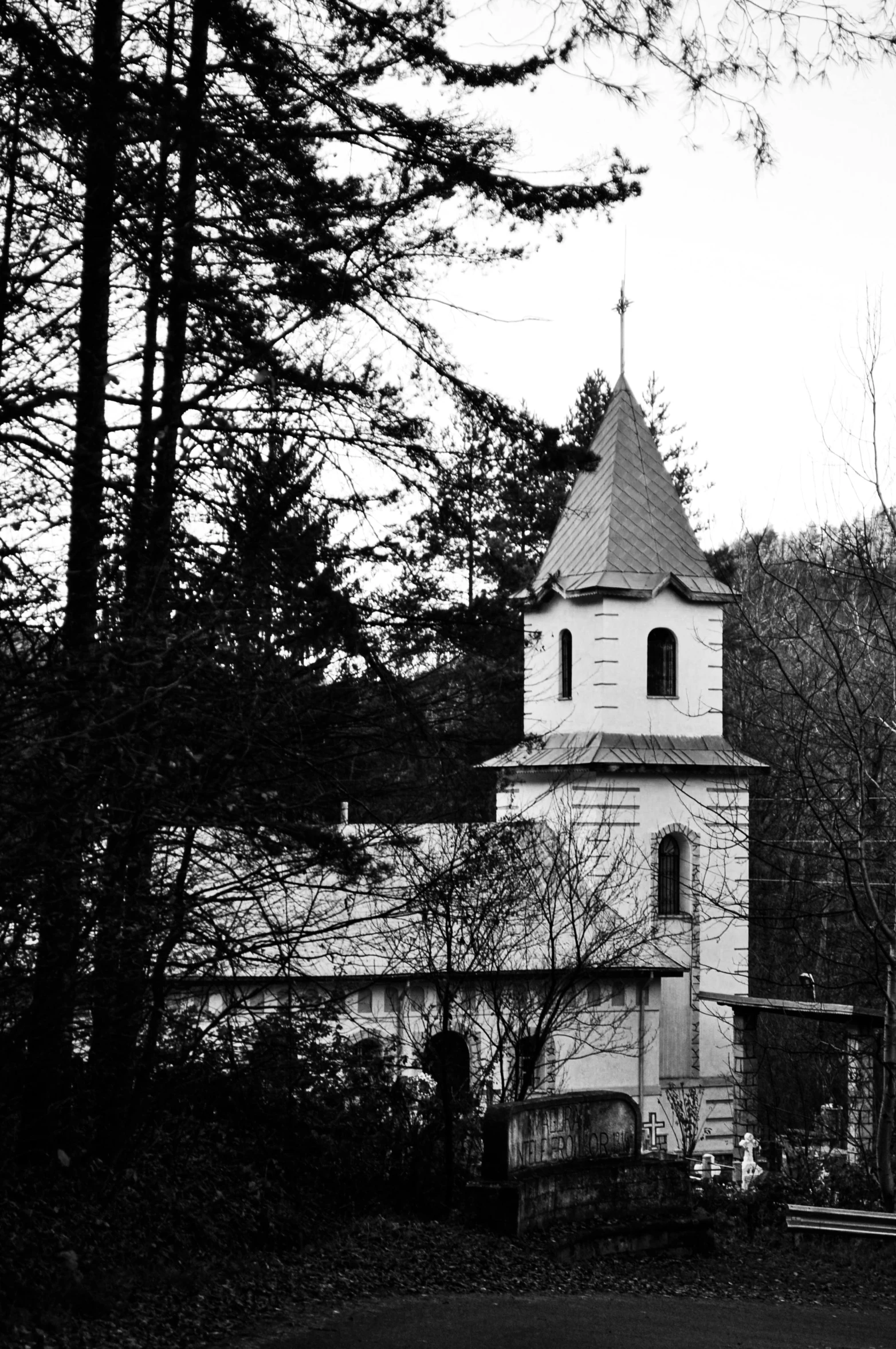 an old building with a steeple in front of trees