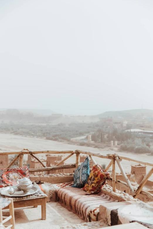 the wooden bench is sitting on a foggy day