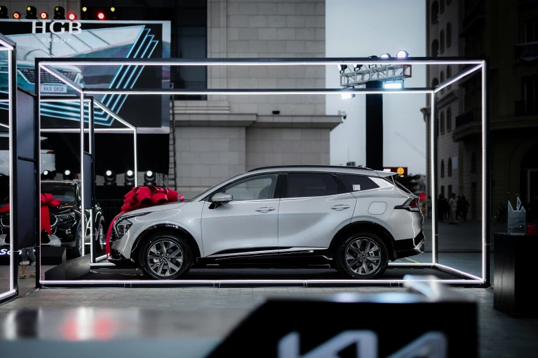 a car is shown through glass and on the sidewalk