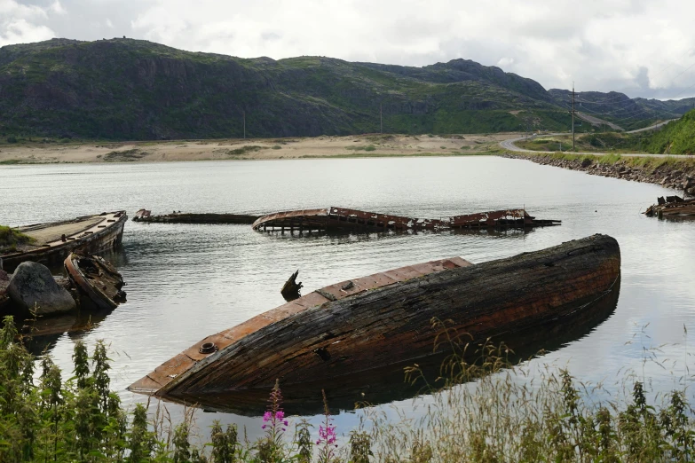 a boat is out in the water near a mountain