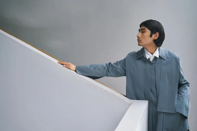 a man standing on top of a stair rail