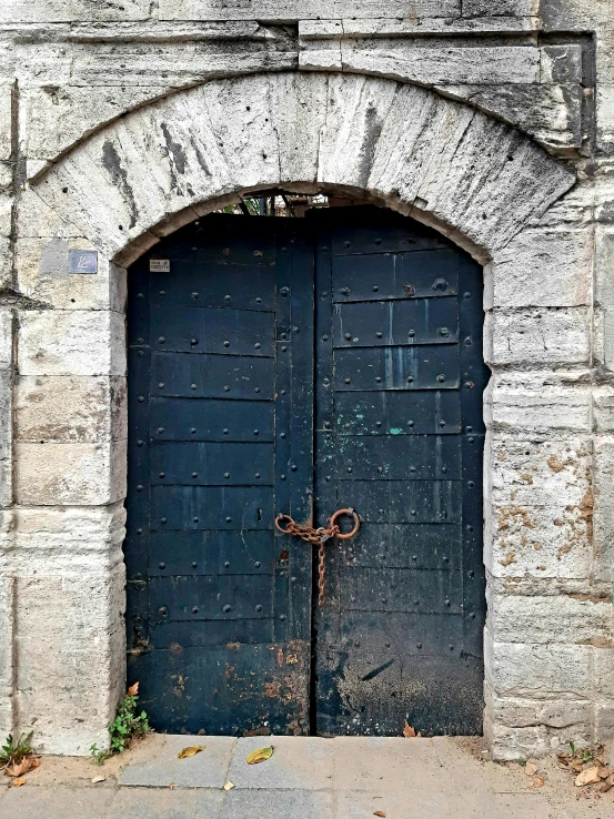a very old doorway with a big door on it