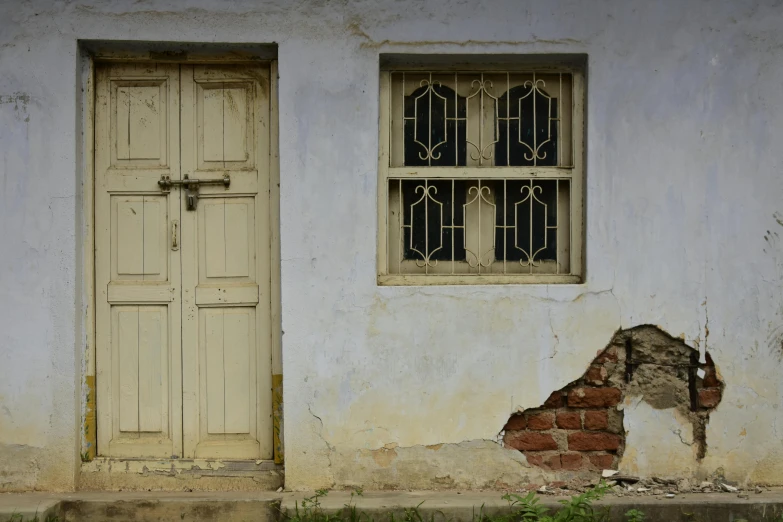 an old wall and windows that have been torn apart