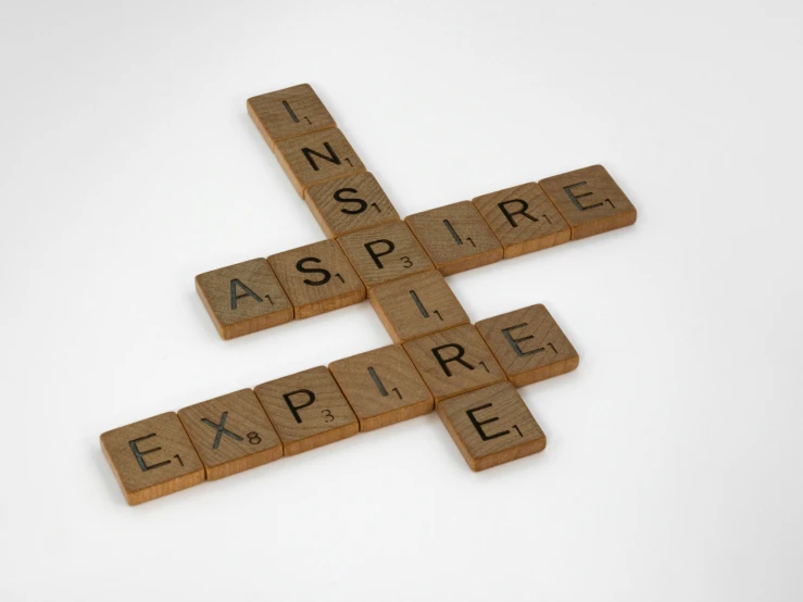 the word inspire spelled out with scrabbled letters