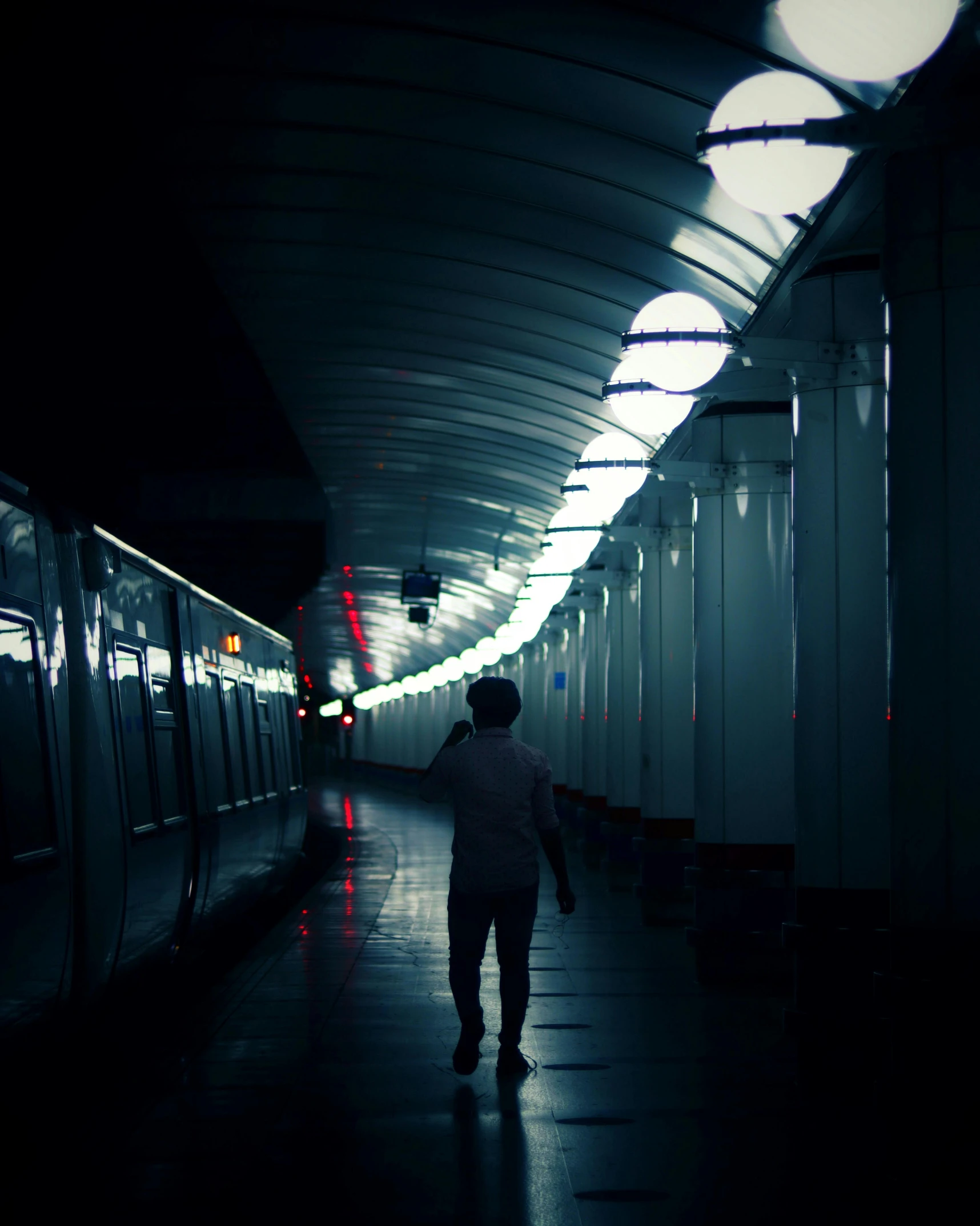 a person is standing alone inside of a train station