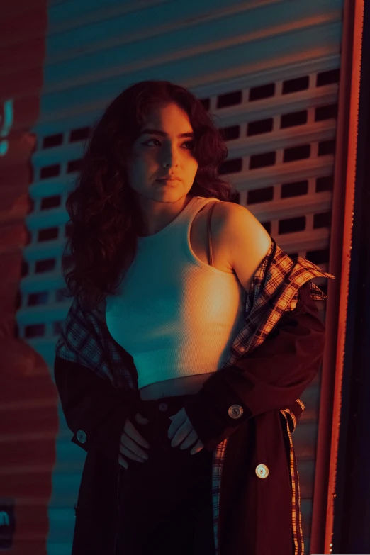 a beautiful woman standing by a door wearing a white top