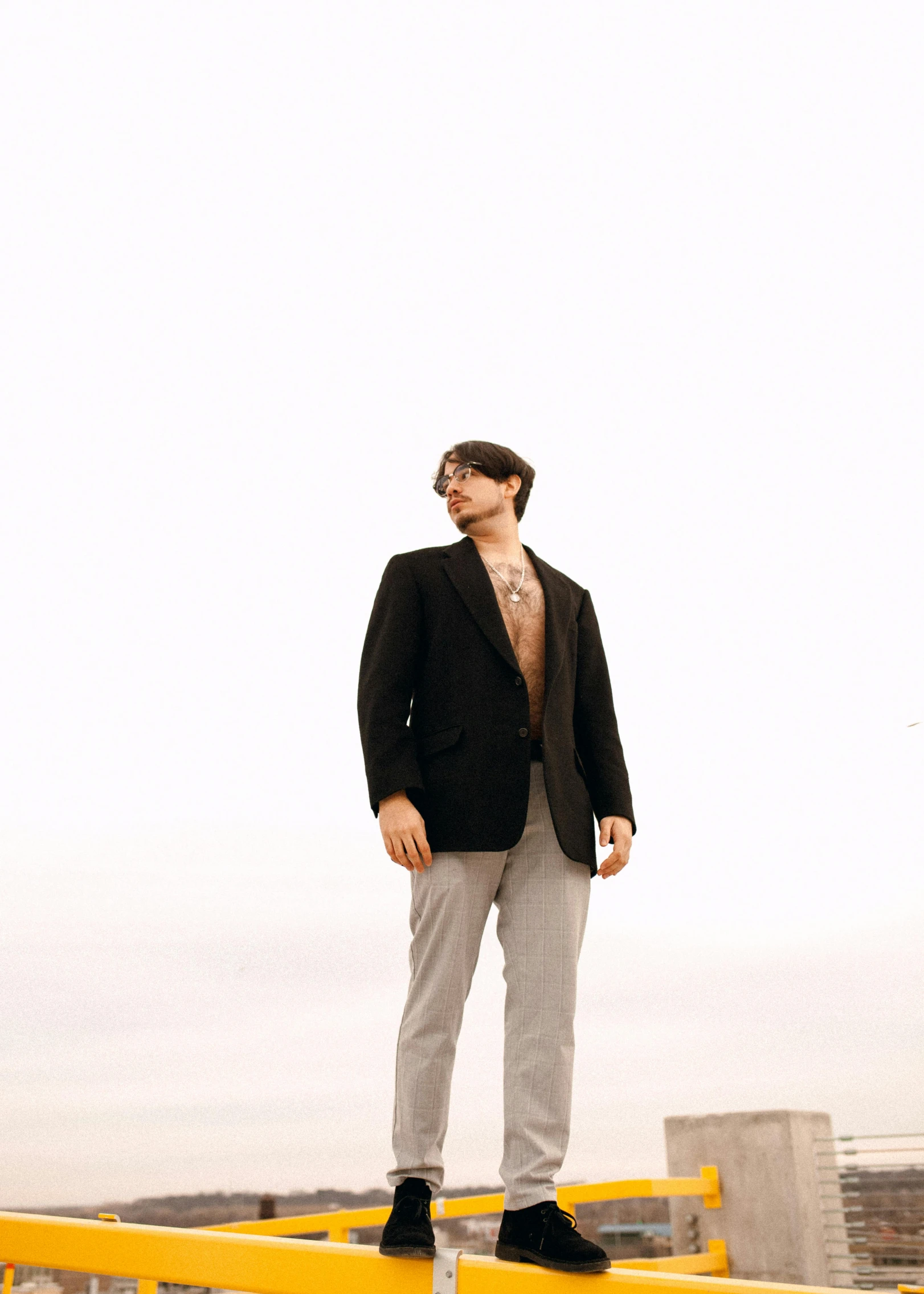 a man standing on top of a metal rail