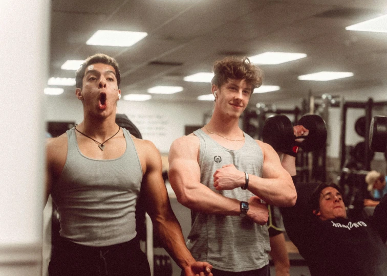 two guys in gym gear posing for a picture