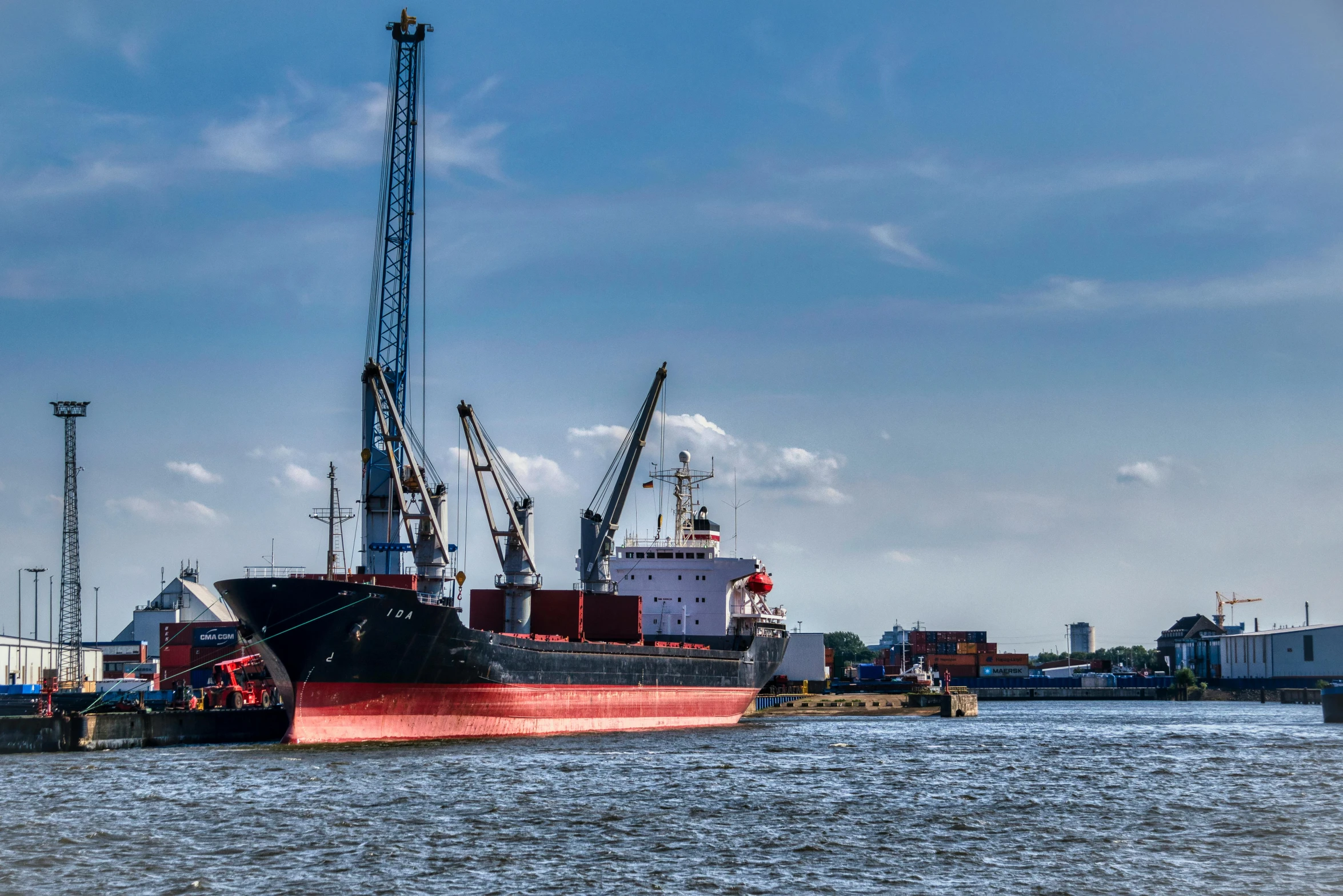 a red ship is sitting in the water