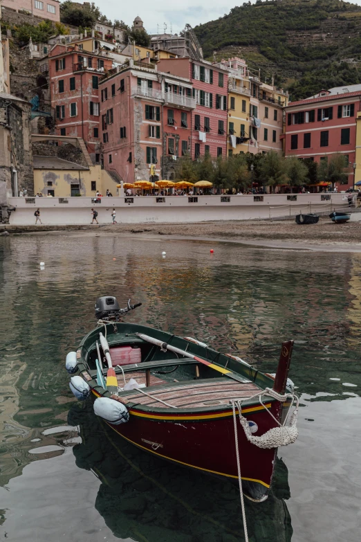 small boat sitting in the middle of water near buildings