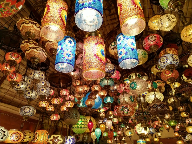 lamps and chandeliers on the ceiling inside a shop