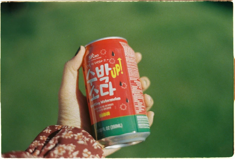 a close up of a hand holding an energy drink